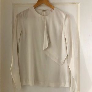 Off-white silky blouse.